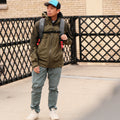 Person wears the ADV Pickleball Bag Pro as a backpack on a city street.