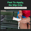 Hands wrapping white MaxTac overgrip onto a tennis racquet handle on a court bench.