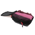 Open ADV packing cube filled with folded clothes, red YKK zipper pulls visible.