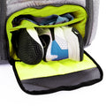 Tennis backpack with shoe compartment shown open, storing athletic shoes and clothes inside a ventilated section.
