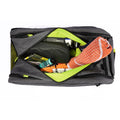 Tennis backpack with compartments fully unzipped, revealing organized storage for towel, grips, accessories, and gear.