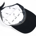 Interior of white and black ADVantage tennis cap showing branded sweatband and mesh lining.
