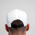 Rear view of white ADVantage tennis cap with black adjustable strap, worn on-model.
