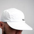 White ADVantage tennis cap with perforated side panels worn on a person, side profile.