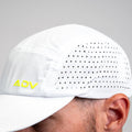 White ADVantage tennis cap with volt logo and perforated side panel, worn on-model.