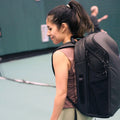 Tennis Backpack V2 lifestyle photo with player at outdoor court