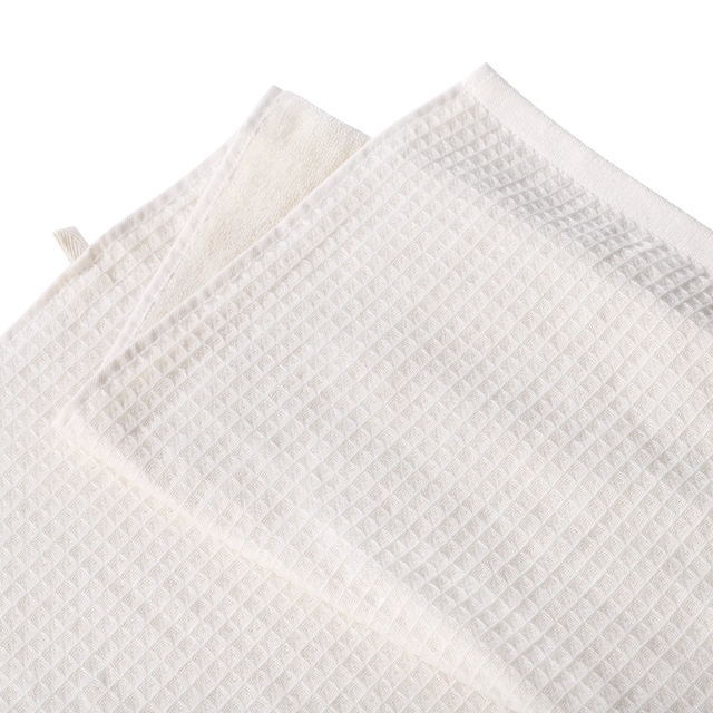 White waffle-knit tennis towels with a soft textured weave on a transparent background.