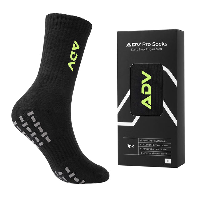 Black ADV Pro Tennis Sock in size M with green logo and grip sole next to its retail packaging.
