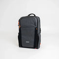 ADV RPM Flex Backpack in charcoal grey with orange zipper pulls, front three-quarter view.